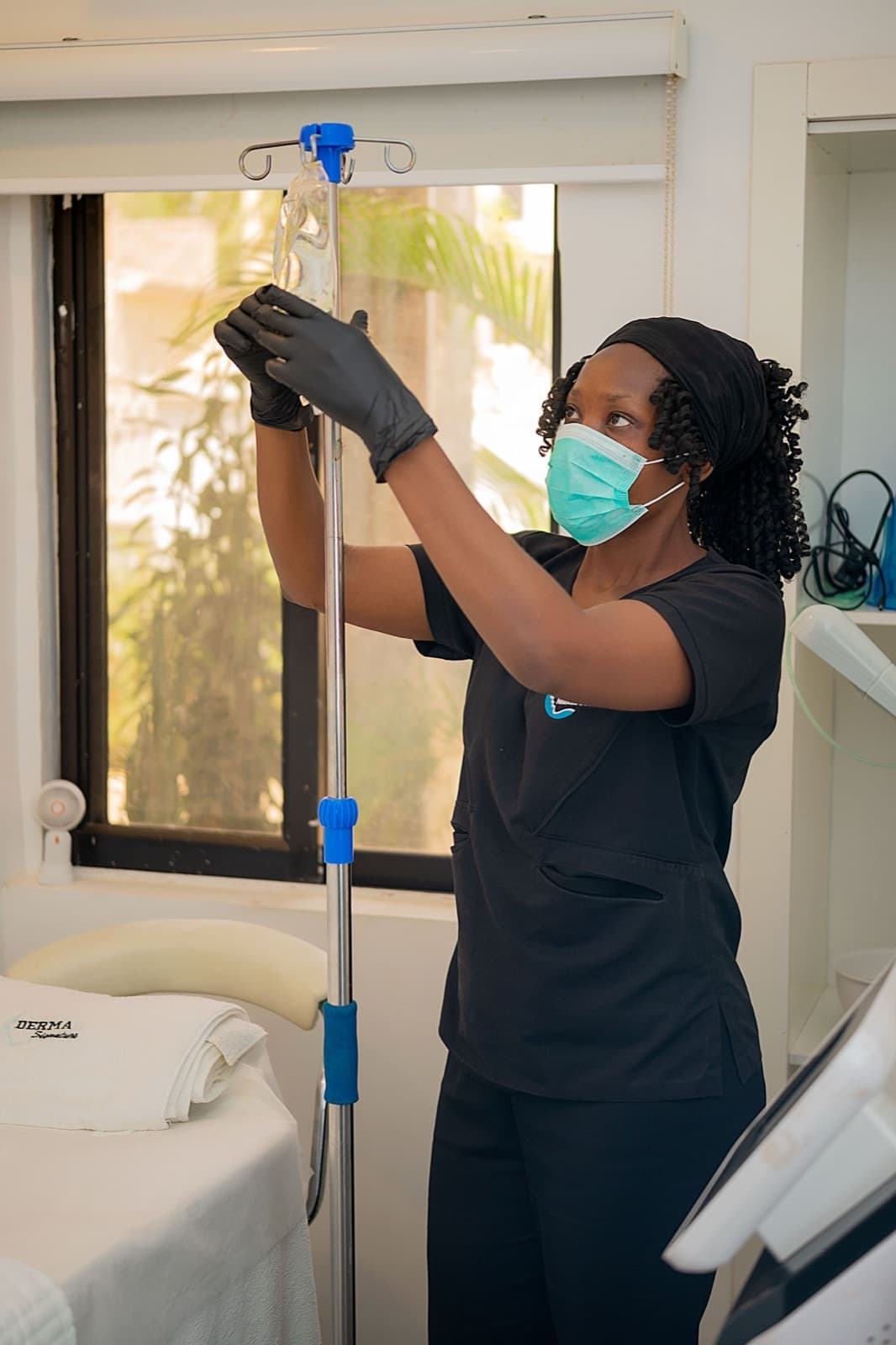 Clinician preparing an IV infusion bag in a treatment bay